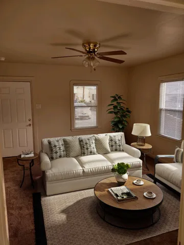 a living room with furniture and a dining room