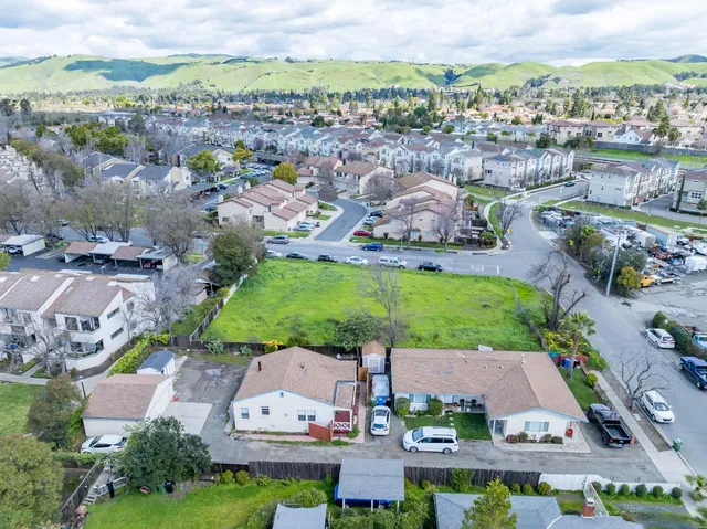 an aerial view of residential houses with outdoor space