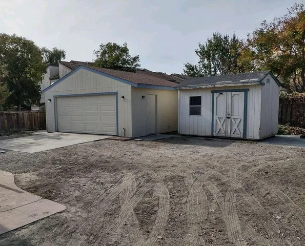 a view of house with yard and garage