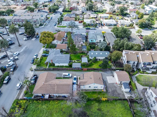 an aerial view of a house with garden space and a street view