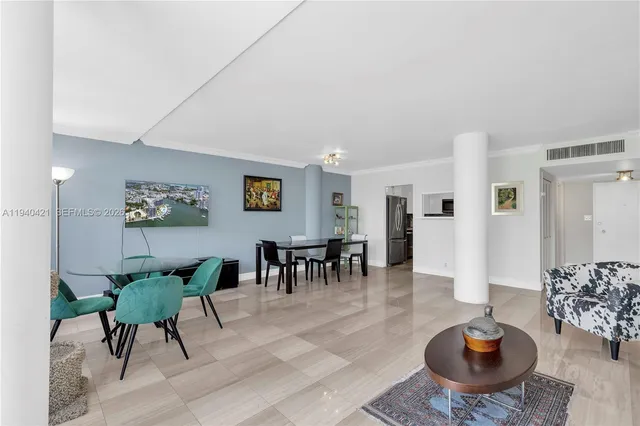 a living room with furniture a rug and a table