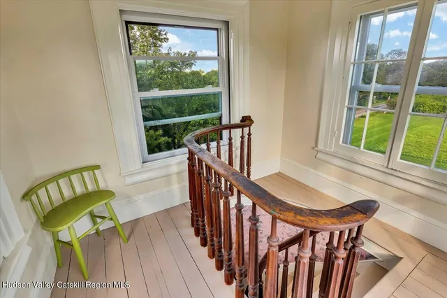 a front view of a house with barbeque grill and brick wall