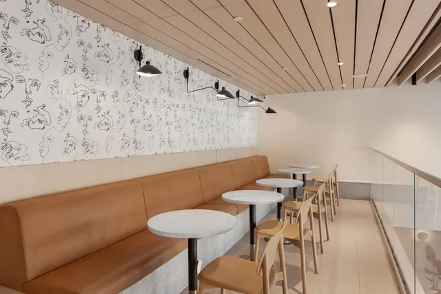 a living room with furniture a mirror and a potted plant