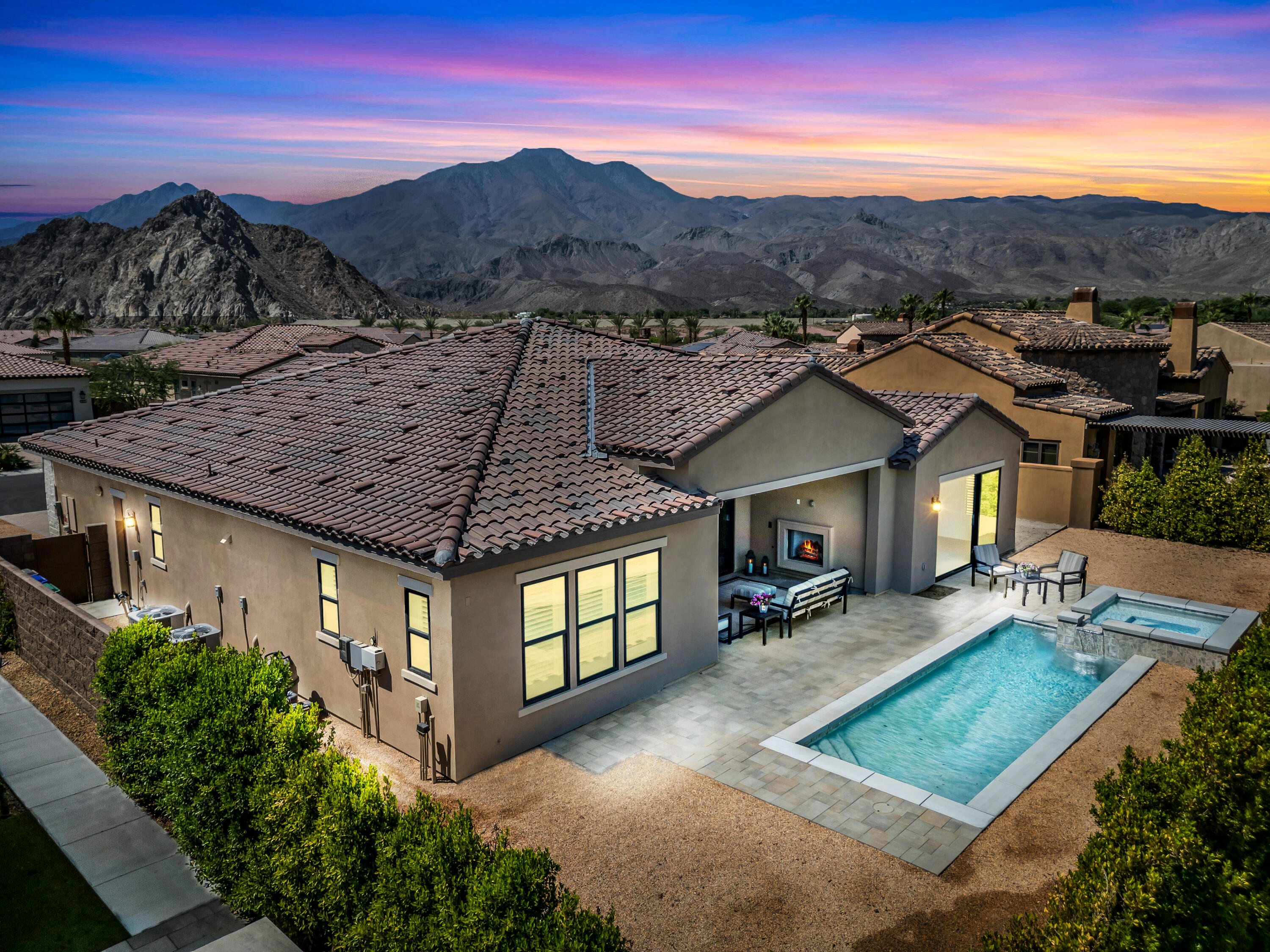 a view of a house with a yard and mountain view
