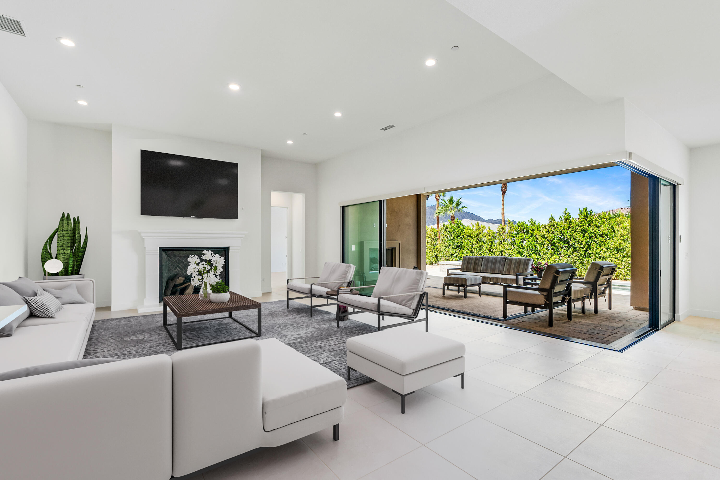 80404 Old Ranch Trail South La Quinta, CA 92253 - Photo 2 of 28 a living room with fireplace furniture and a flat screen tv