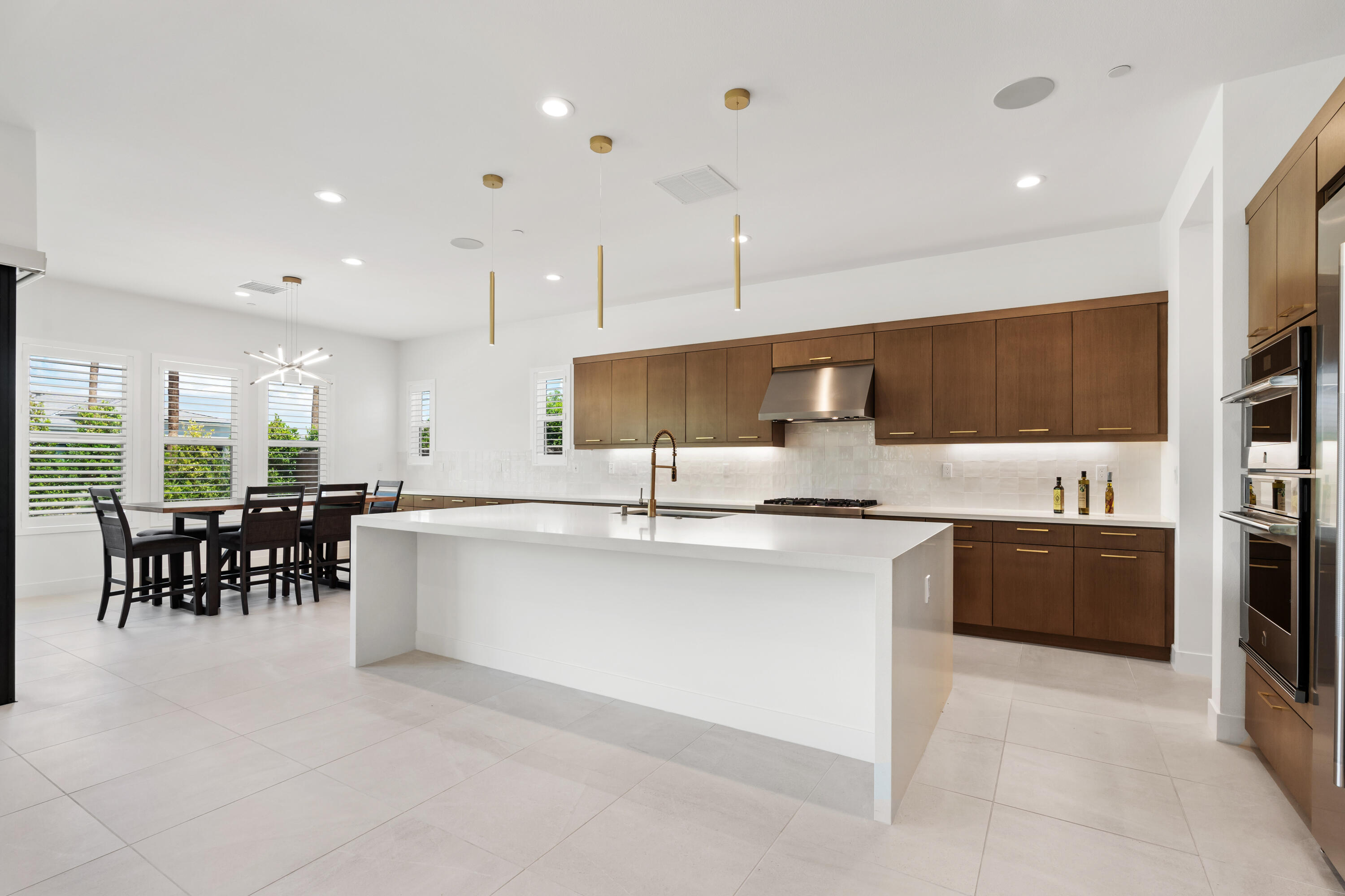 80404 Old Ranch Trail South La Quinta, CA 92253 - Photo 4 of 28 a large kitchen with a table and chairs