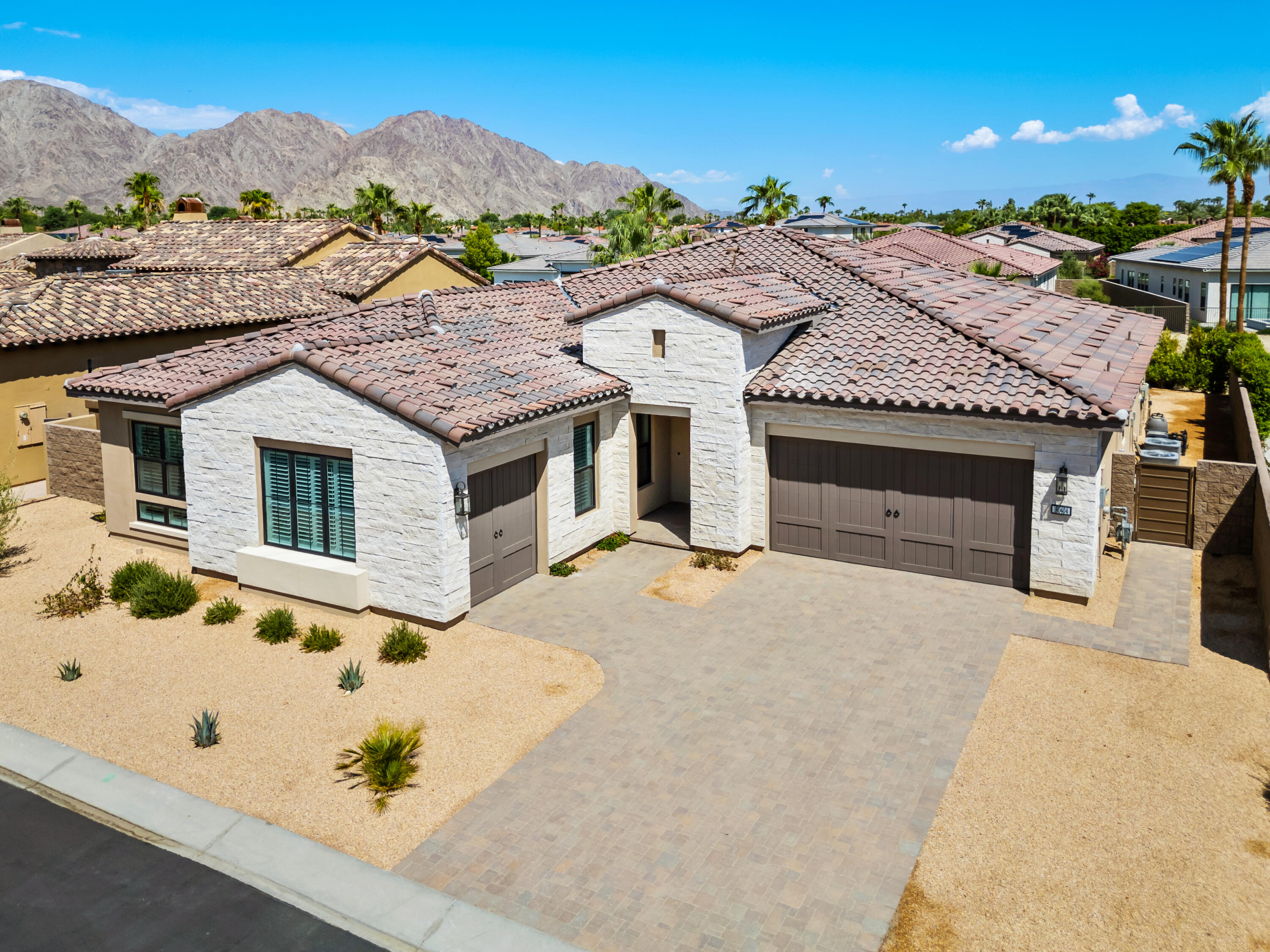 80404 Old Ranch Trail South La Quinta, CA 92253 - Photo 10 of 28 a front view of a house with a yard and mountain view