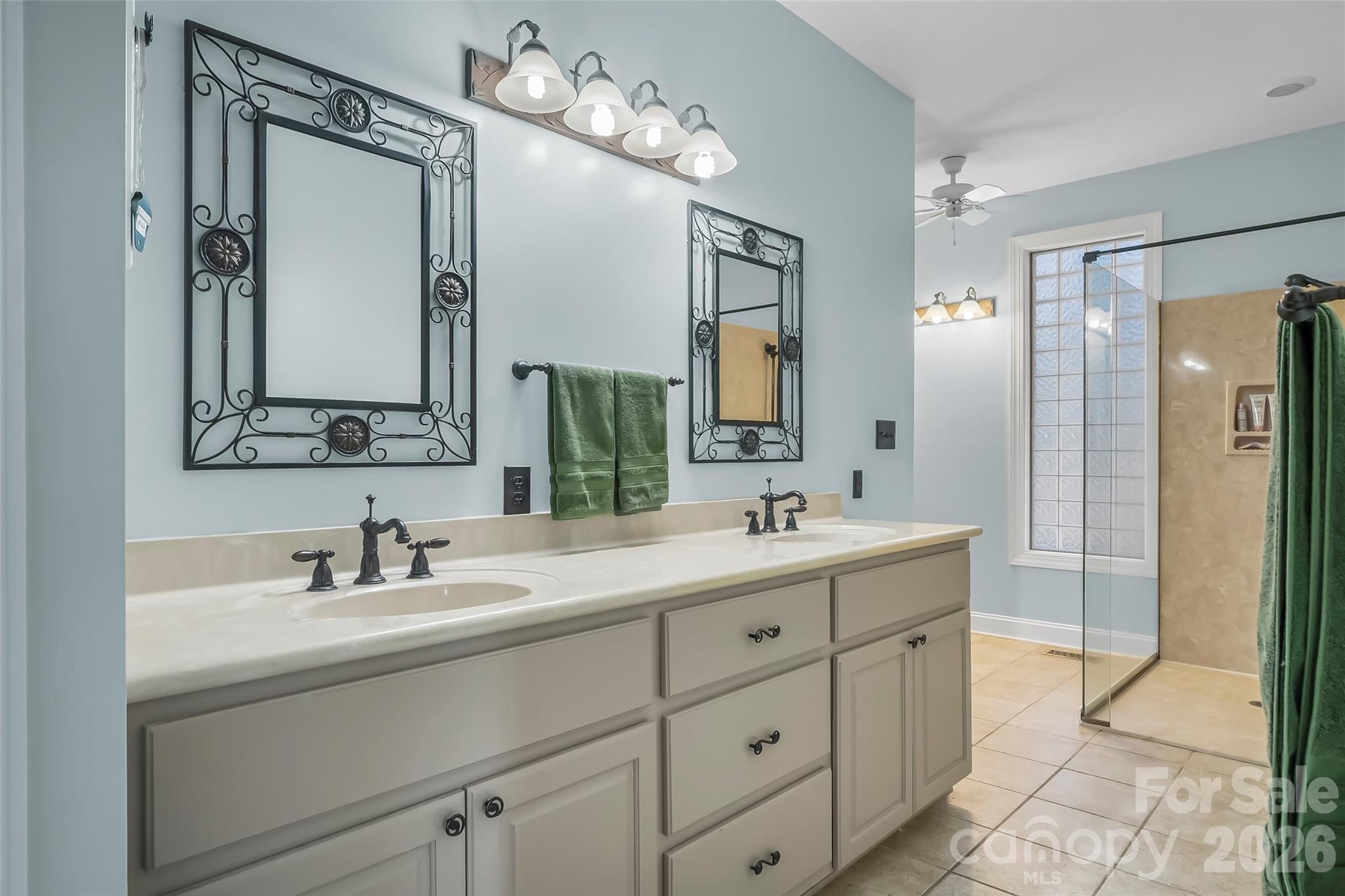 4639 Harbor View Terrace Morganton, NC 28655 - Photo 11 of 33 a bathroom with a double vanity sink mirror and shower