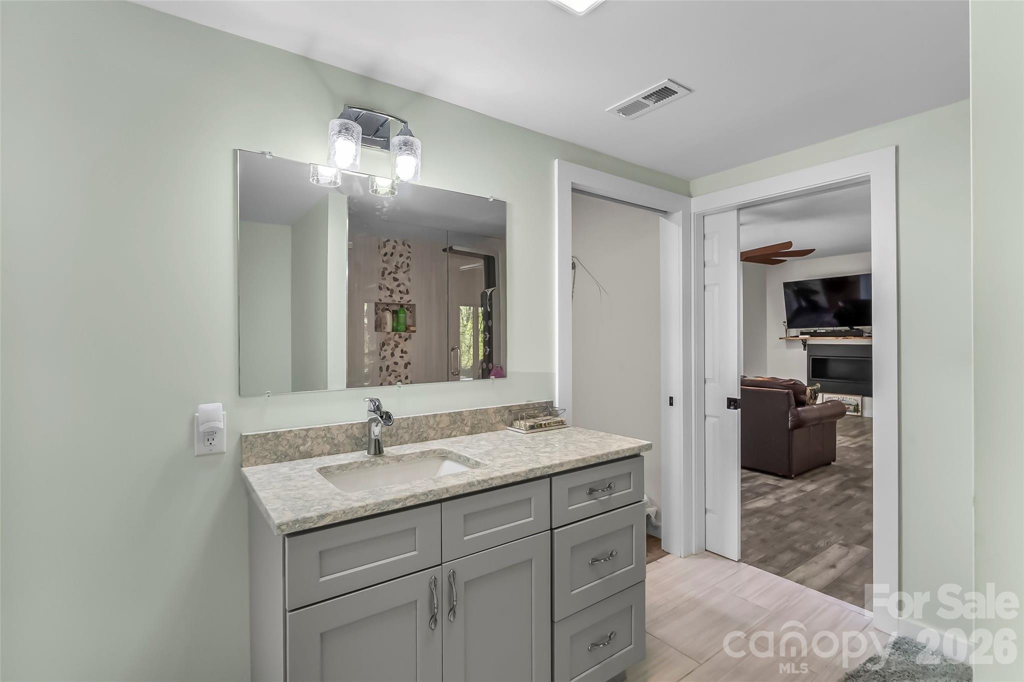 4639 Harbor View Terrace Morganton, NC 28655 - Photo 21 of 33 a en suite bathroom with a sink and mirror