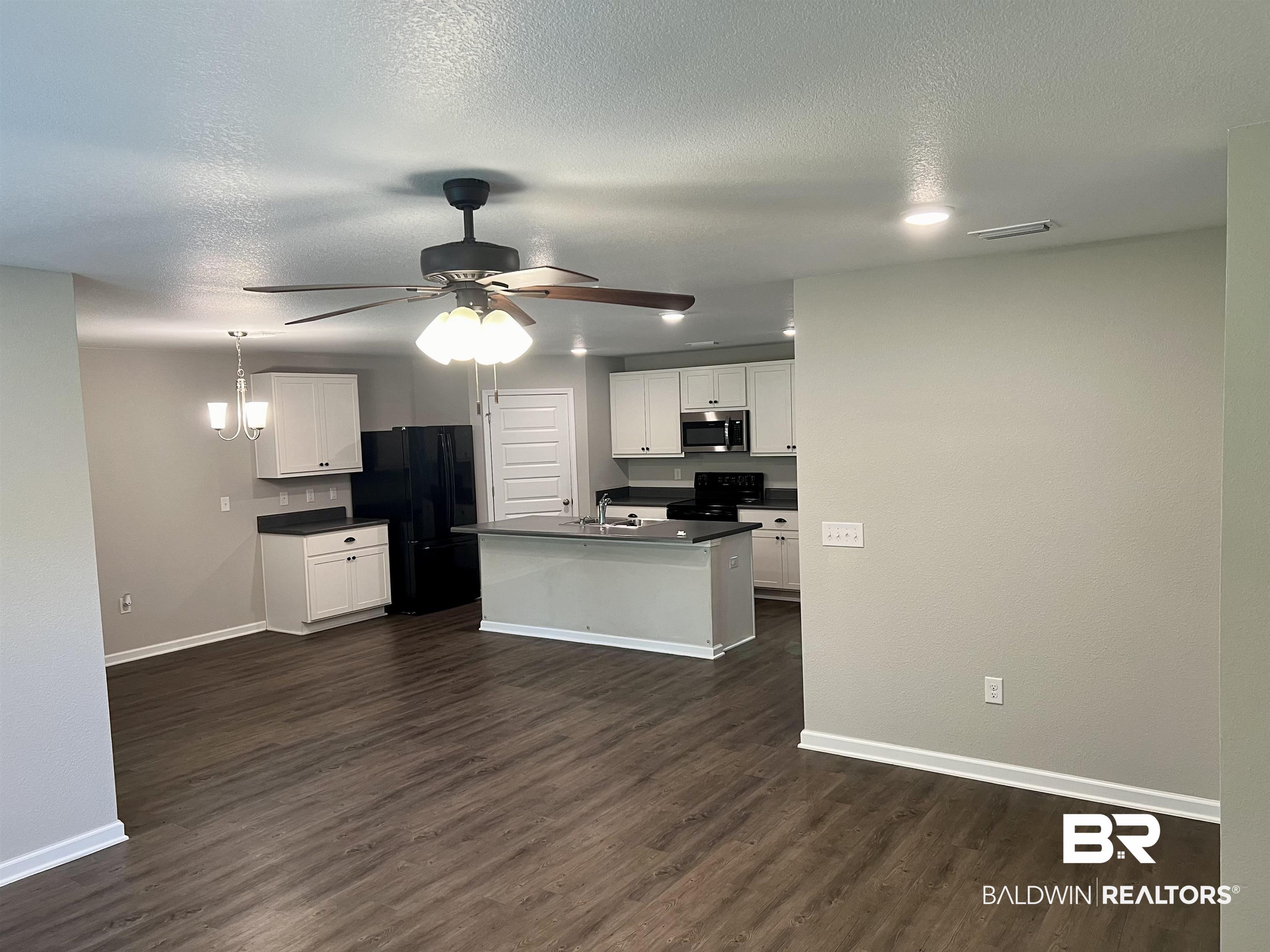 1612 Abbey Loop Foley, AL 36535 - Photo 14 of 30 Kitchen with ceiling fan, dark hardwood / wood-style flooring, white cabinetry, sink, and black appliances