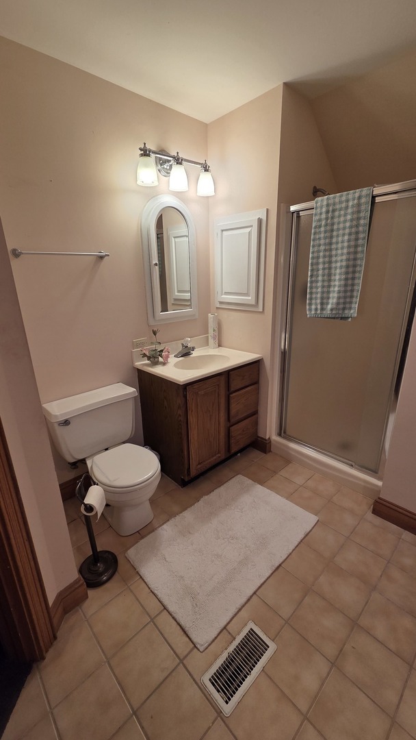 2502 Van Drunen Lane Crete, IL 60417 - Photo 35 of 58 a bathroom with a sink mirror vanity and toilet