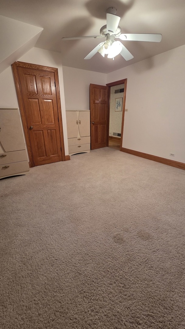 2502 Van Drunen Lane Crete, IL 60417 - Photo 41 of 58 a view of an empty room with a chandelier fan