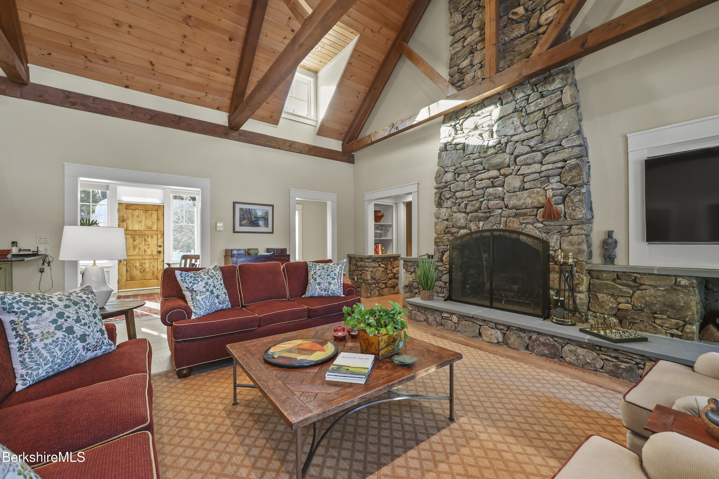 201 Stratford Road New Marlborough, MA 01259 - Photo 12 of 77 a living room with furniture a flat screen tv and a fireplace