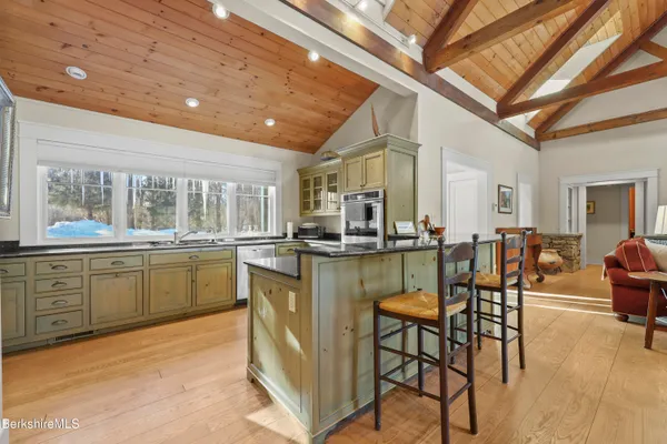 a kitchen with stainless steel appliances granite countertop a refrigerator and a stove top oven