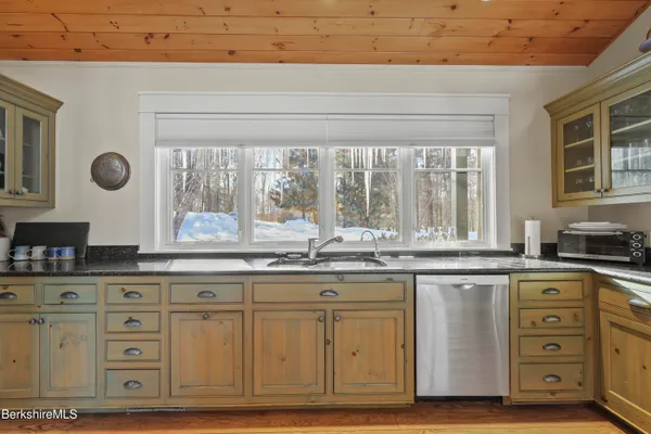 a spacious bathroom with a granite countertop sink toilet and shower