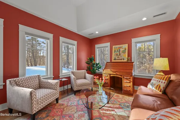 a bedroom with bed couch and window