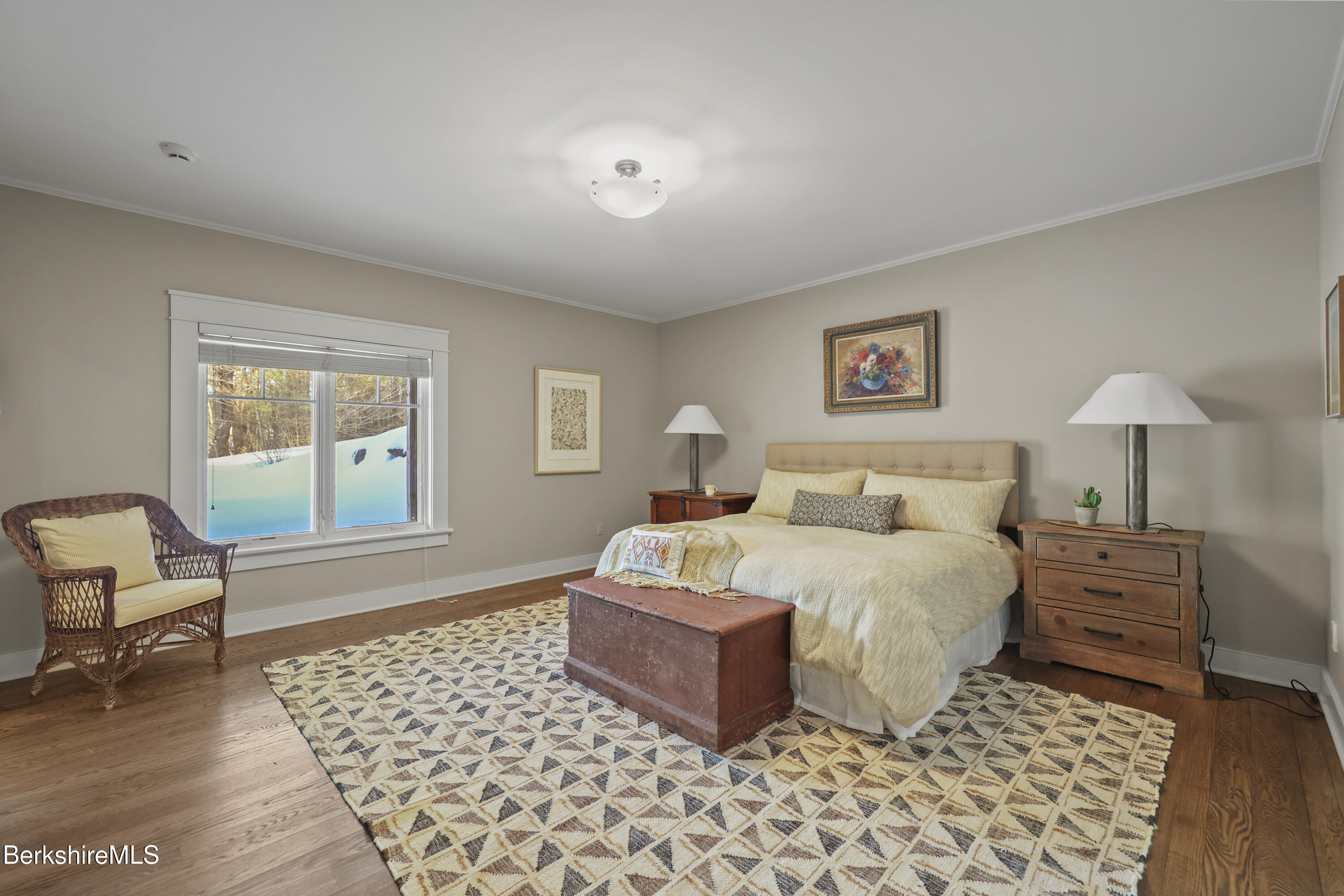 201 Stratford Road New Marlborough, MA 01259 - Photo 47 of 77 a spacious bedroom with a bed and a chair