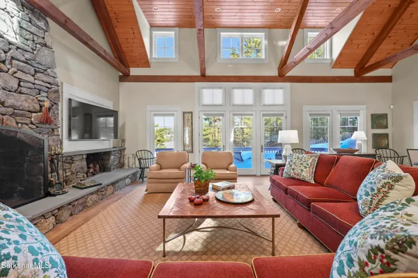 a living room with furniture a table and a large window