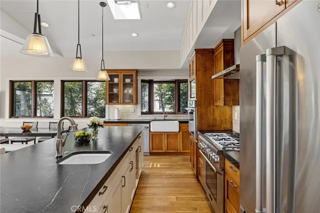 a kitchen with stainless steel appliances granite countertop a lot of counter space and a sink