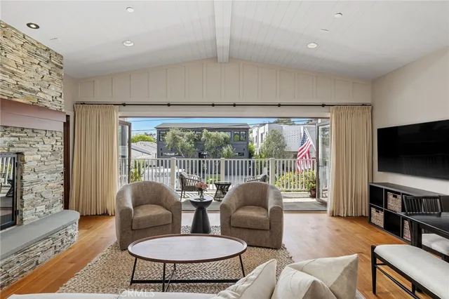 a living room with furniture a rug and a flat screen tv