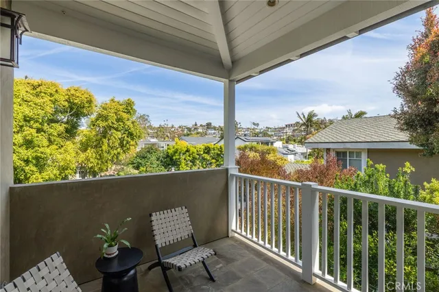 a view of a balcony with chair and a potted plant
