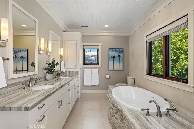 a spacious bathroom with a granite countertop tub and a sink