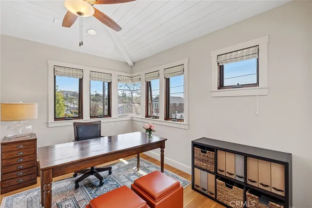 a living room with furniture a table and wooden floor