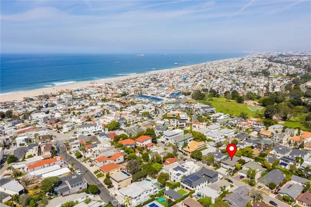 a living room with furniture and a laptop computer sitting on wooden floor