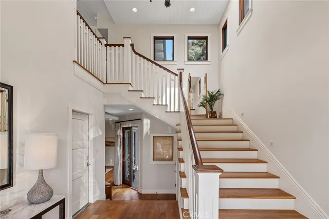 a view of entryway and hall with wooden floor
