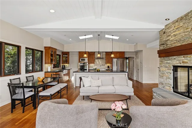 a living room with fireplace furniture and a large window