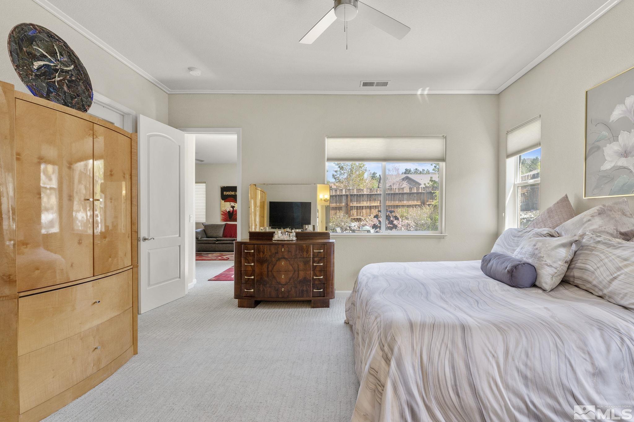 2601 Mule Circle Reno, NV 89521 - Photo 12 of 35 a bedroom with a large bed and a flat screen television