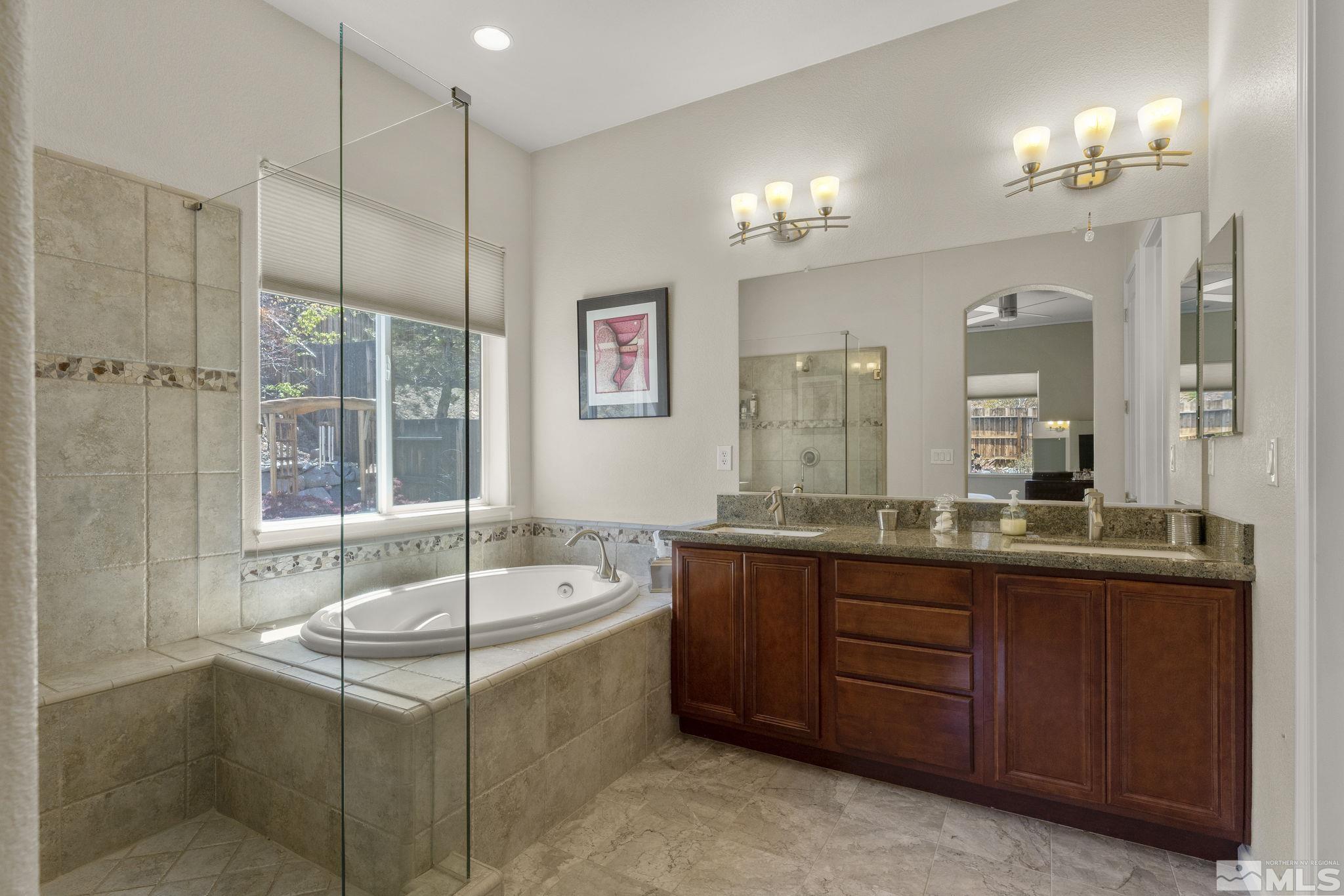 2601 Mule Circle Reno, NV 89521 - Photo 14 of 35 a bathroom with a granite countertop tub sink shower and mirror