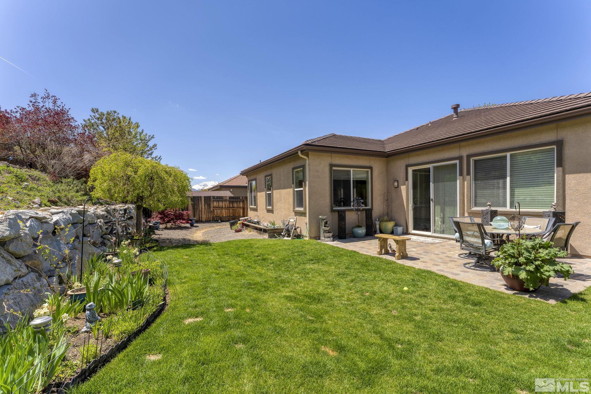 2601 Mule Circle Reno, NV 89521 - Photo 30 of 35 a view of a house with backyard sitting area and garden