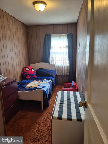 a bedroom with bed and a window