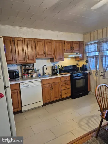 a kitchen with a sink a stove and cabinets