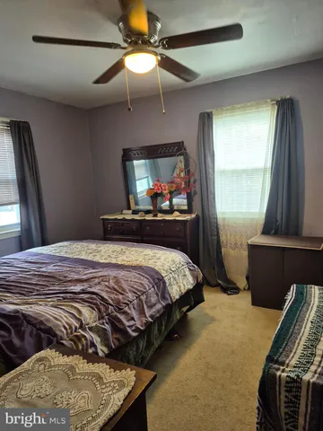 a bedroom with a bed and a mirror