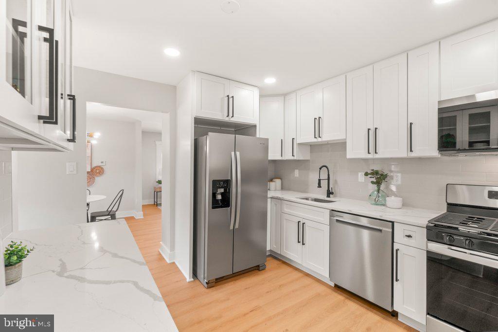 3500 Edwards Street Lanham, MD 20706 - Photo 15 of 40 a kitchen with stainless steel appliances a refrigerator sink and stove