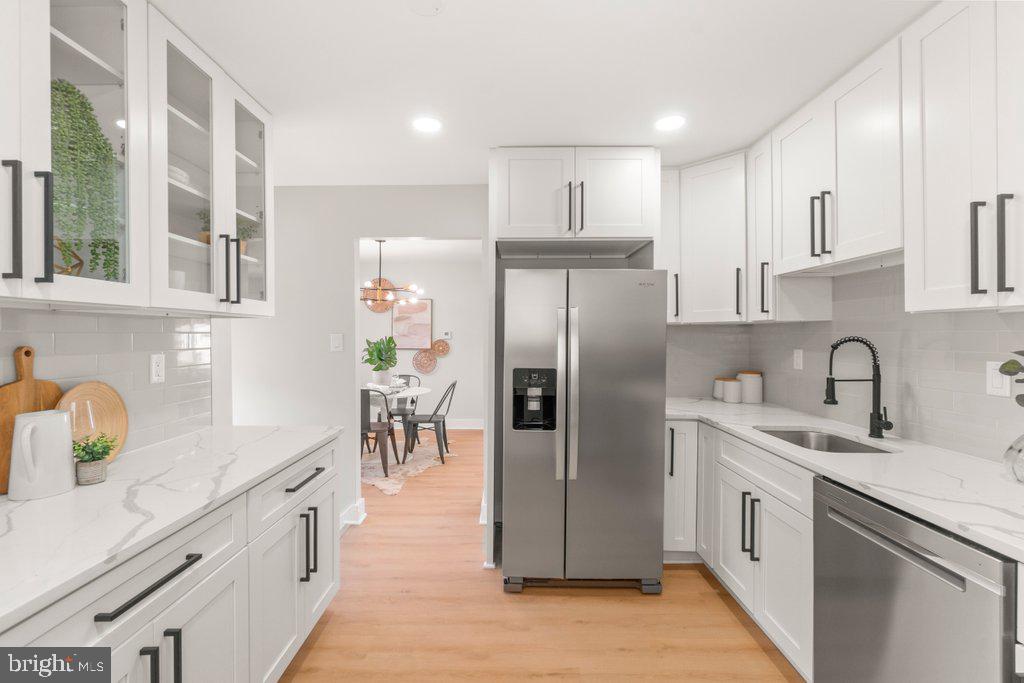 3500 Edwards Street Lanham, MD 20706 - Photo 16 of 40 a kitchen with stainless steel appliances a refrigerator sink and cabinets