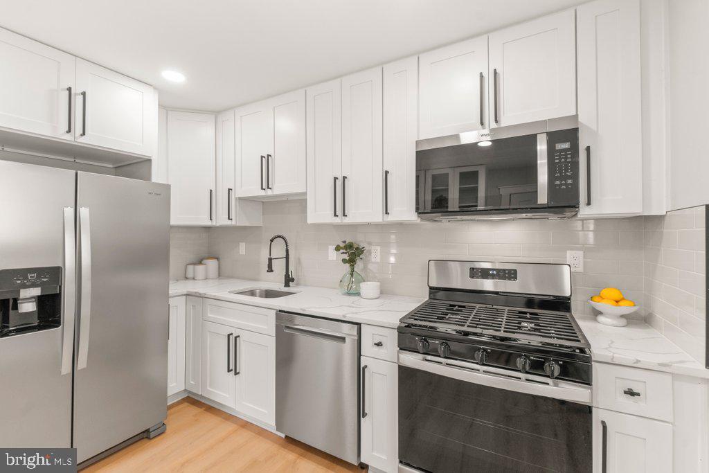 3500 Edwards Street Lanham, MD 20706 - Photo 18 of 40 a kitchen with stainless steel appliances granite countertop a stove a refrigerator and a microwave
