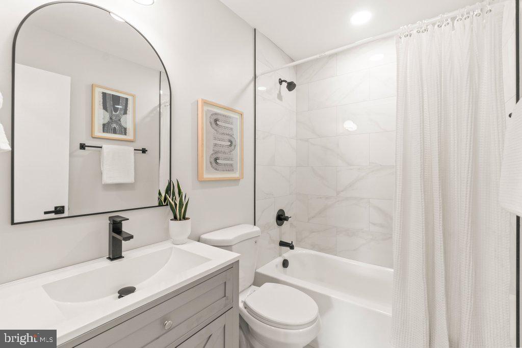 3500 Edwards Street Lanham, MD 20706 - Photo 22 of 40 a bathroom with a sink a toilet and shower