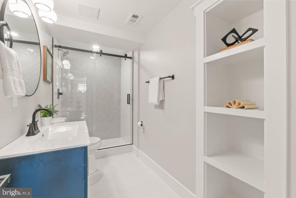 3500 Edwards Street Lanham, MD 20706 - Photo 33 of 40 a bathroom with a shower sink and mirror
