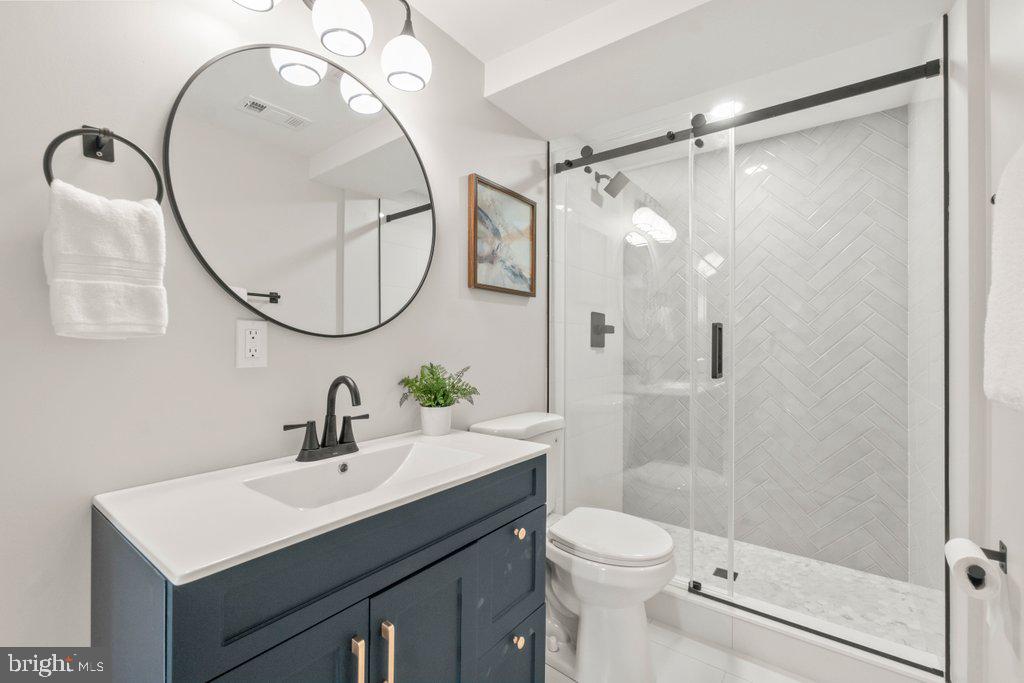 3500 Edwards Street Lanham, MD 20706 - Photo 34 of 40 a bathroom with a sink a toilet and a mirror