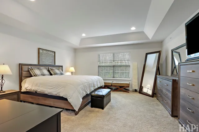 a bedroom with a bed and a flat tv screen