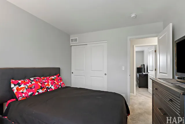a bedroom with a bed and a dresser