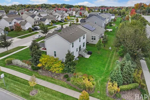 an aerial view of a house with a yard
