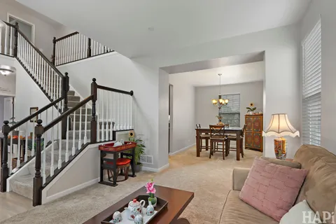 a living room with furniture and a dining table