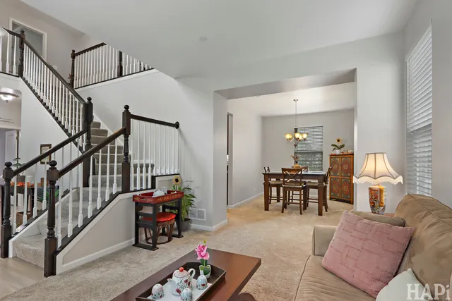 a living room with furniture and a dining table