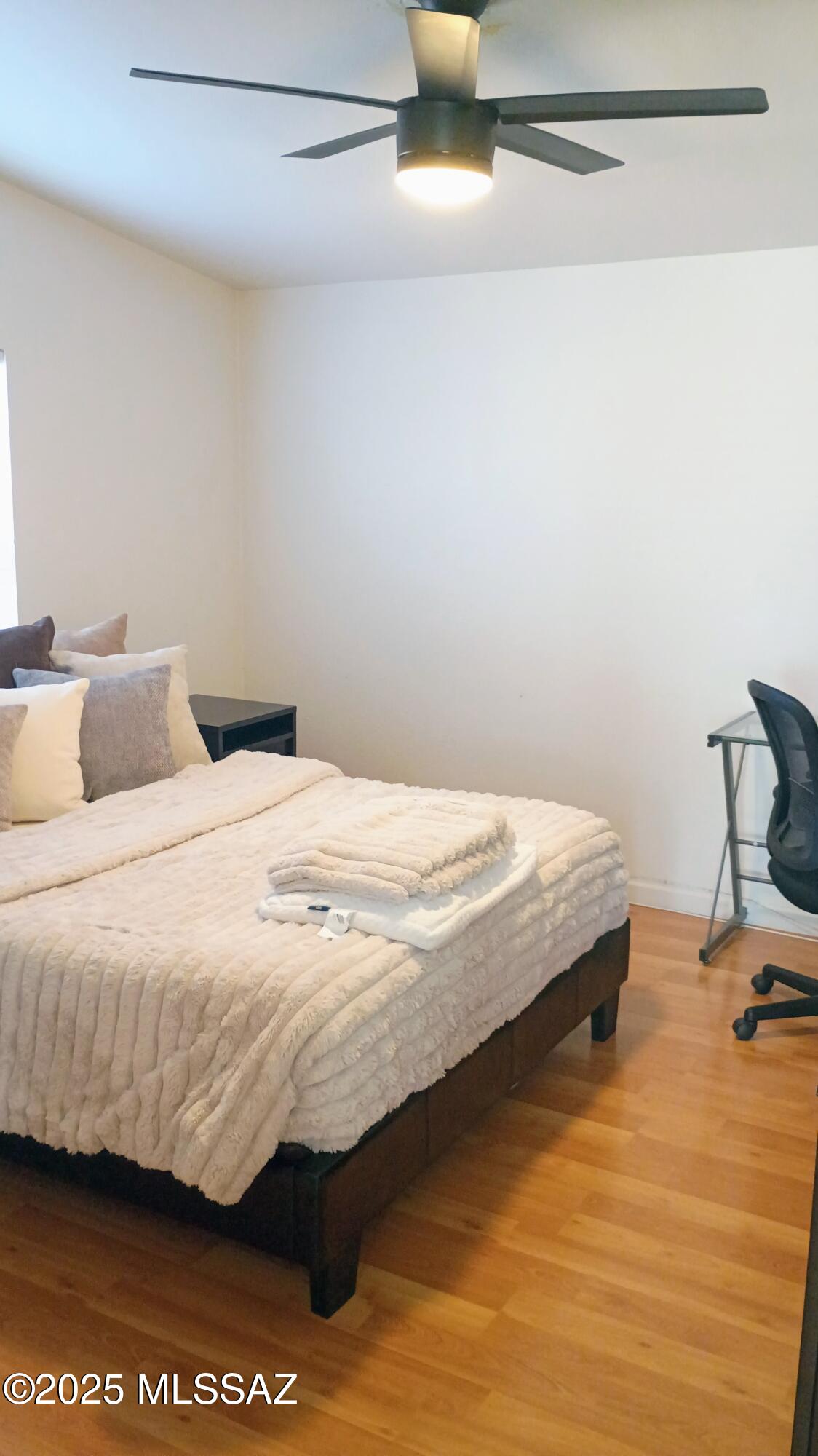 1449 West Hualpai Road Tucson, AZ 85745 - Photo 23 of 49 a bedroom with a bed and wooden floor