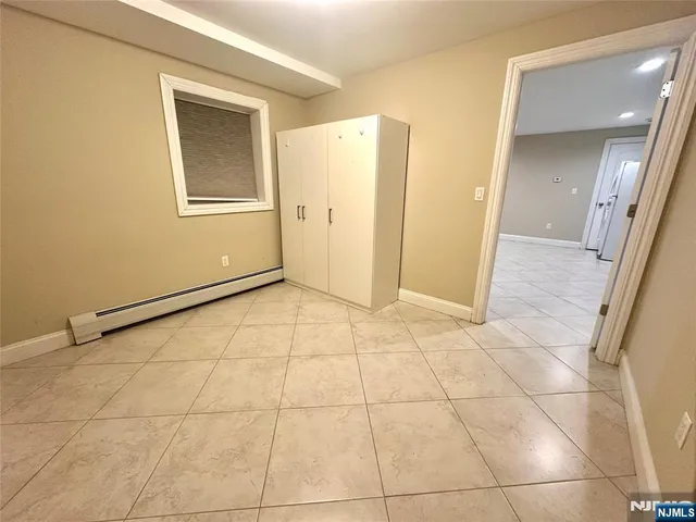 a view of a livingroom with an empty space and a window