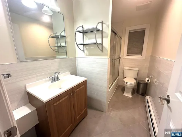 a bathroom with a sink toilet and mirror